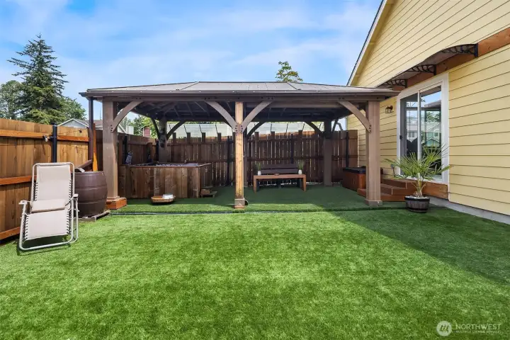 Side yard gazebo/hot tub. Seller added a sliding glass door from living room.