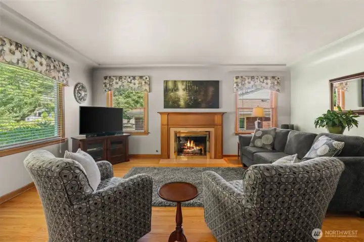 The heart of the home. This spacious living room centers around a cozy fireplace, perfectly complemented by rich hardwood floors and an abundance of natural light. The heart of the home. This spacious living room centers around a cozy fireplace, perfectly complemented by rich hardwood floors and an abundance of natural light.