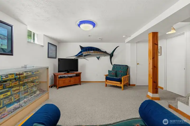 The ultimate lower-level retreat! This spacious downstairs basement is perfectly set up as the ultimate media room. An ideal space for game days, movie nights, or just hanging out with friends. The ultimate lower-level retreat! This spacious downstairs basement is perfectly set up as the ultimate media room. An ideal space for game days, movie nights, or just hanging out with friends.
