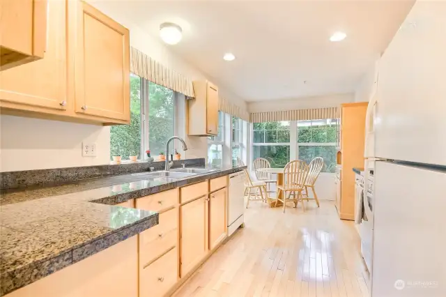 Big beautiful kitchen with hardwood floors, granite counters, plenty of cabinets & counter space plus big eating nook with lots of windows to let in all the natural light