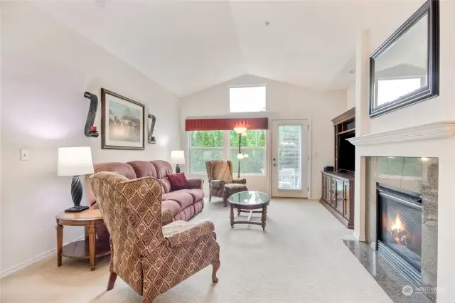 Spacious living area with gas fireplace & large niche for your entertainment center or bookcase.