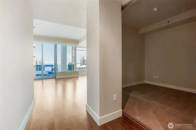 View of bedroom and living space from entrance of unit.
