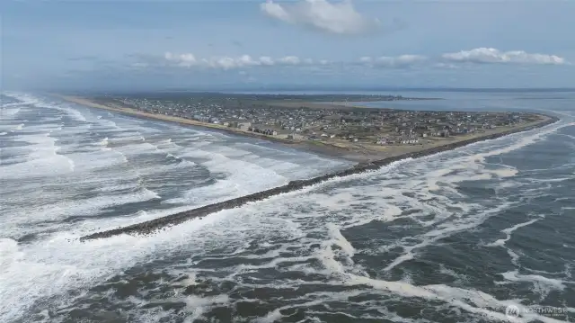 YOU CAN JUST MAKE OUT THE CONDO IN BACKGROUND AS THE DRONE SWINGS AWAY FROM THE OCEAN INTO THE JETTY AND CHEHALIS RIVER!
