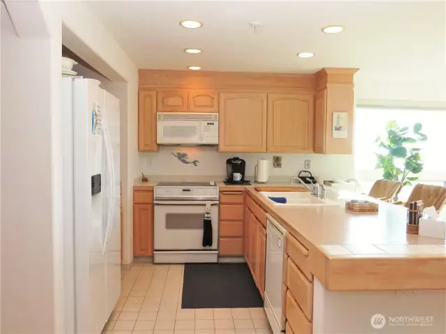 KITCHEN HAS BEAUTIFUL CABINETS WITH PLENTY OF COUNTER SPACE FOR MEAL PREP, TILE FLOORING AND ALL THE APPLIANCES YOU WILL NEED TO LIVE COMFORTABLY AT THE BEACH!