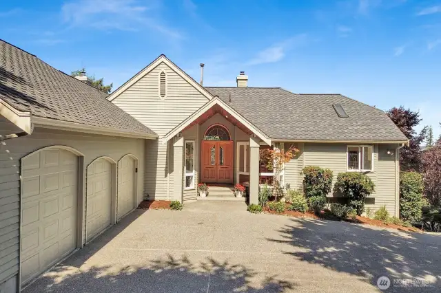 Privacy abounds with large parking area in front of oversized 3-car garage