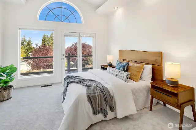 The main level primary bedroom has access to the wrap-around deck