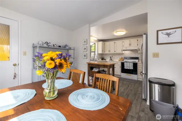 Cheerful dining area with fully-equipped kitchen.