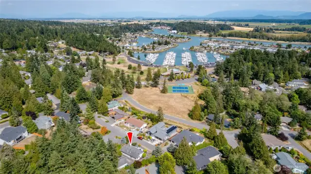A view of the athletic court, pool, marina, and golf course (to the left.) All within walking distance. La Conner is a 5 minute drive.