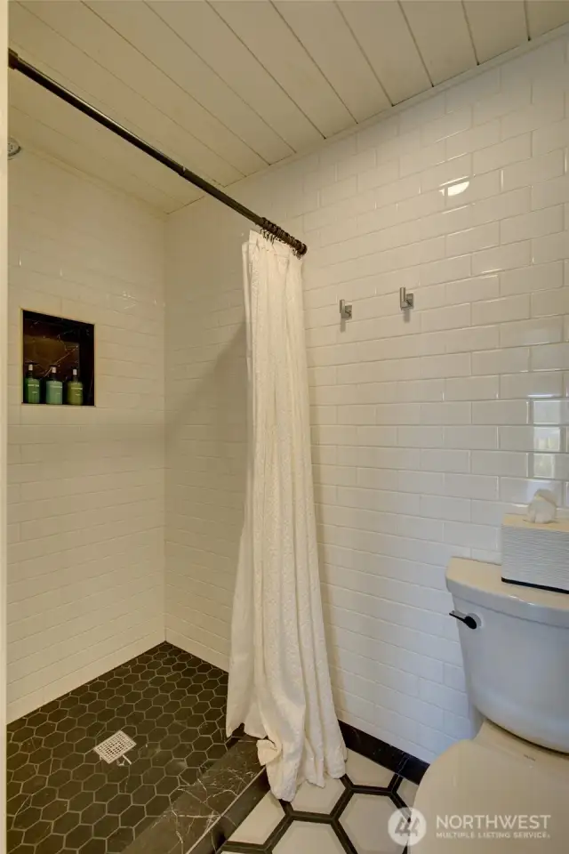 Primary bath has a gorgeous, custom tiled shower.