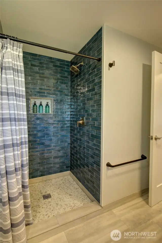 Custom tile work throughout both units is a testament to the quality of the craftsmanship involved in the remodel.