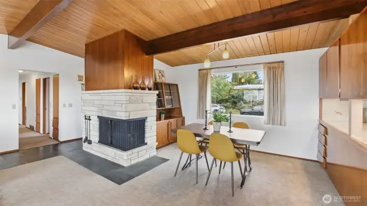 Statement stone fireplace anchors the living and dining spaces with timeless character.