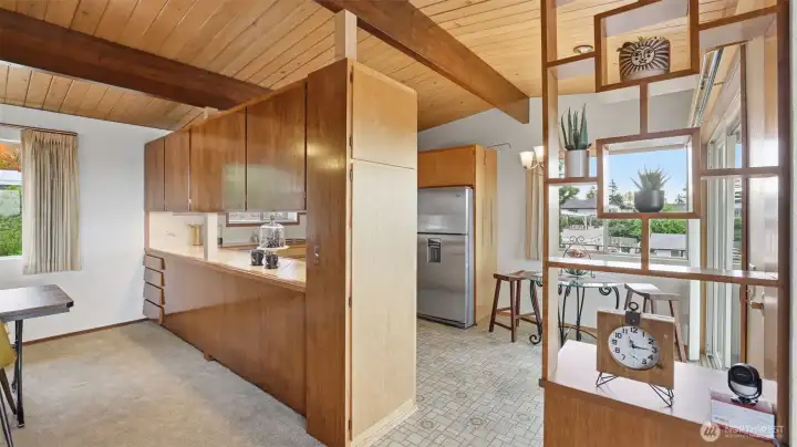Warm wood cabinetry and architectural room dividers showcase thoughtful mid-century craftsmanship.