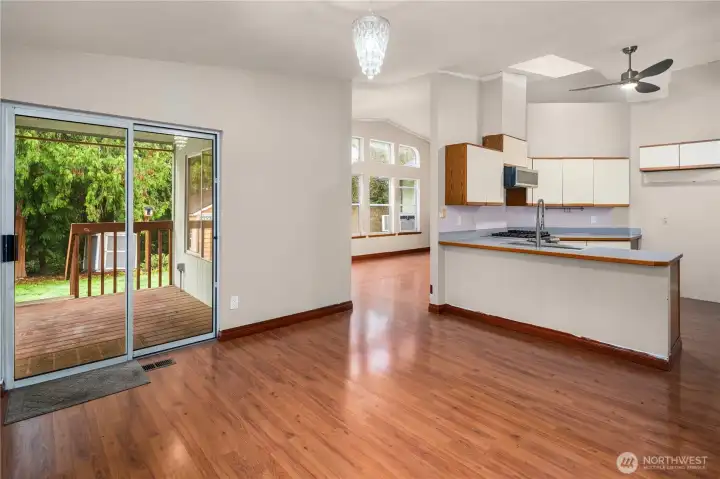 Open layout connects the kitchen and living spaces, with convenient deck access—great for gatherings.