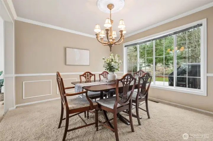 Large formal dining room - with a huge bank of windows, medallion on the ceiling with dramatic light fixture.
