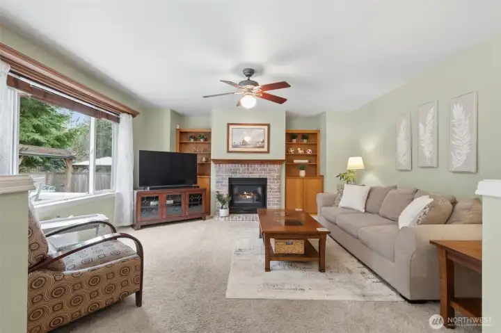 Family room off the kitchen - with ceiling fan, gas fireplace, built-ins and another HUGE window looking out onto the deck.