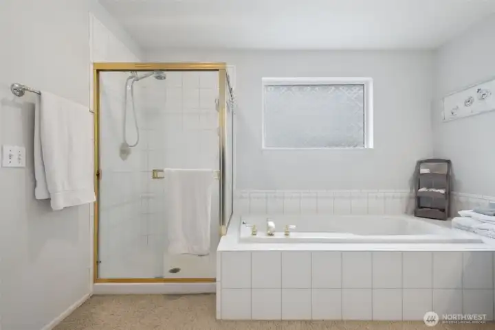 A view showing the large stand up tiled shower, and the soaking tub.