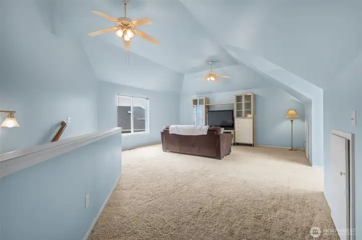 Another view of the bonus room with the stairs on the left. Many have used this for multigenerational living because the stairway comes out near the door from the garage into the house.