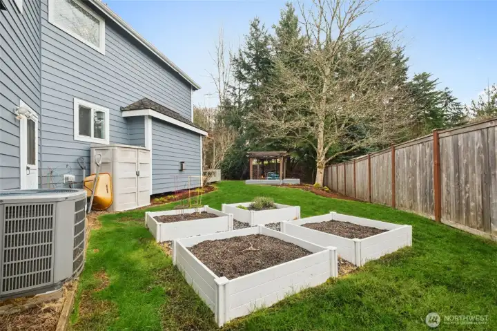 Garden beds on the sunny side of the yard (note the AC unit too).