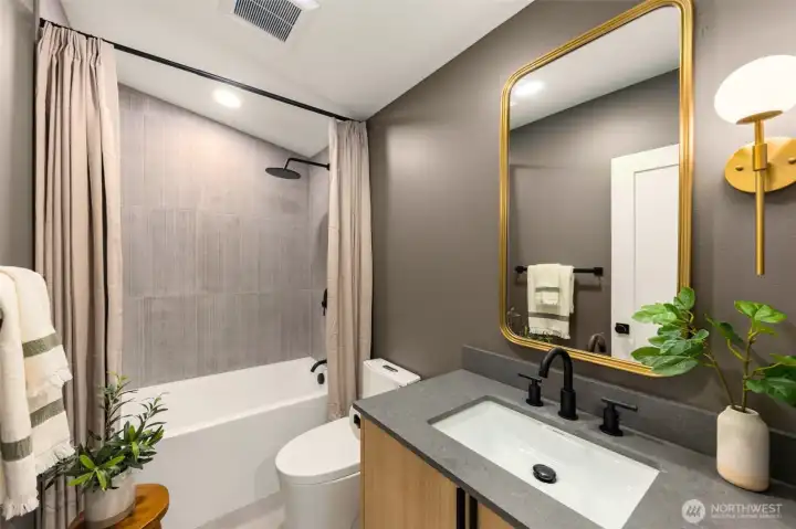 Just upstairs, you will find the first of two bathrooms. Featuring a deep full tub & two shower heads, a rainfall head and handheld shower head for a full spa experience.