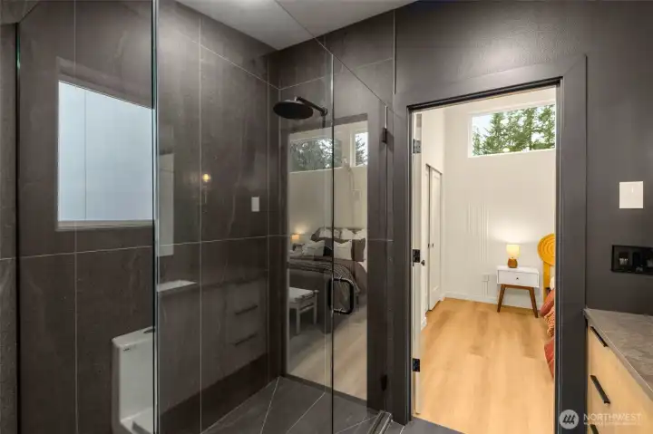 Two showerheads located in primary shower, one handheld and one rainfall