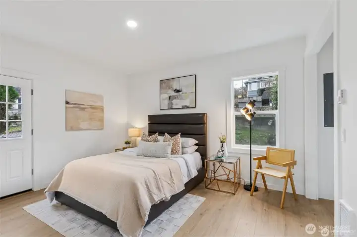Primary Bedroom with a walk-in closet, and ensuite bathroom on the main level. Door to back porch.