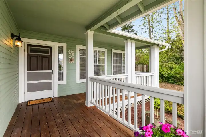 The generous covered front patio creates an inviting first impression and a comfortable space to welcome guests.