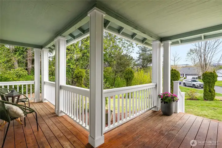 City-owned land adjacent to the property—visible to the left in this photo—enhances privacy while you relax on the front porch.