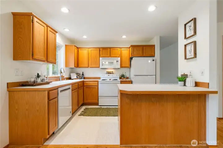 This spacious, beautifully appointed kitchen features an inviting eating bar and flows seamlessly into the dining and family rooms—an ideal setting for effortless entertaining.