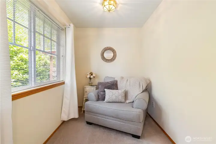 Close up view of sitting area in this large primary bedroom.