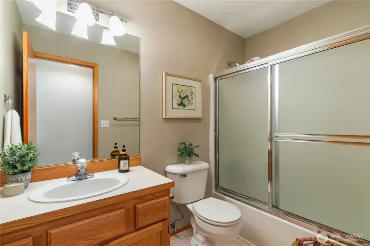 This 2nd full bathroom is located next to the laundry room.