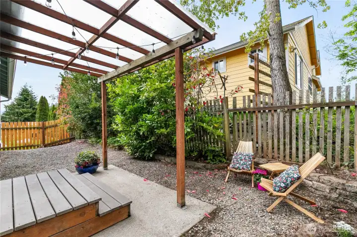 The covered backyard patio, paired with low-maintenance landscaping, offers a serene and inviting retreat.