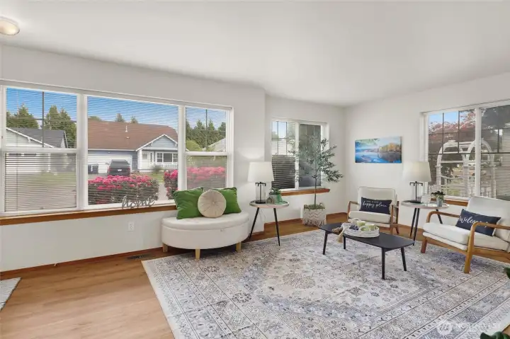 Sunlight pours through abundant windows, enhancing the home’s open and welcoming feel.