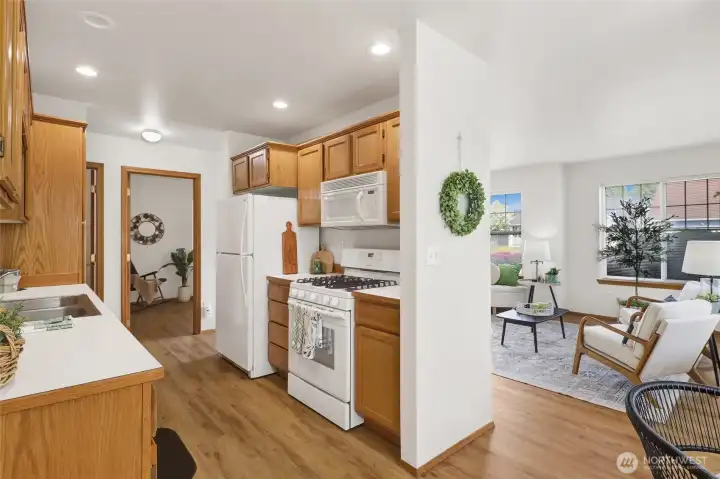 The kitchen offers easy flow to both the dining nook and bedroom wing.