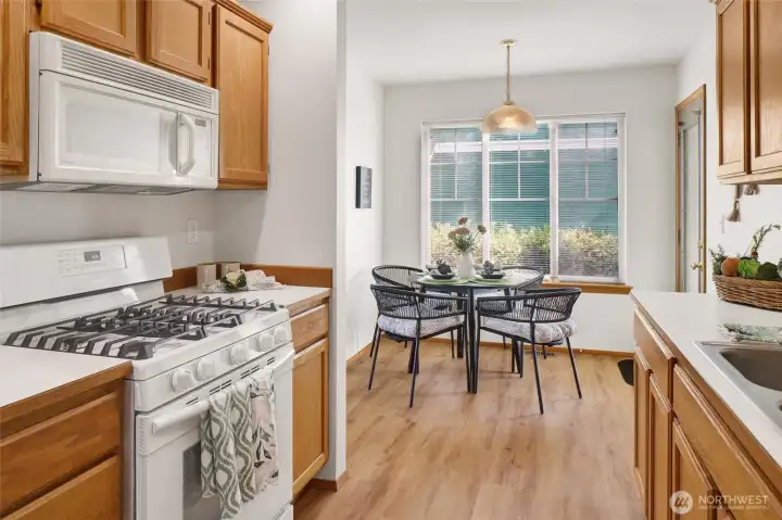 A gas range brings chef-inspired convenience to this bright and practical kitchen.