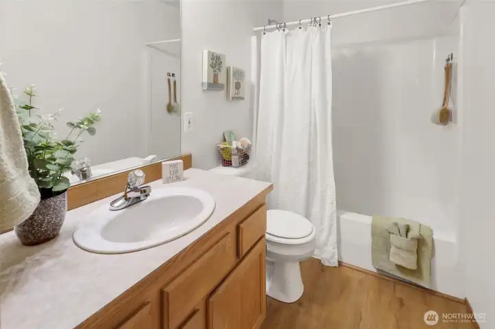 The full bath is situated across from the primary bedroom.