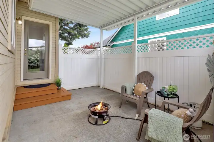 Imagine cool evenings gathered around the fire pit on this inviting covered patio.
