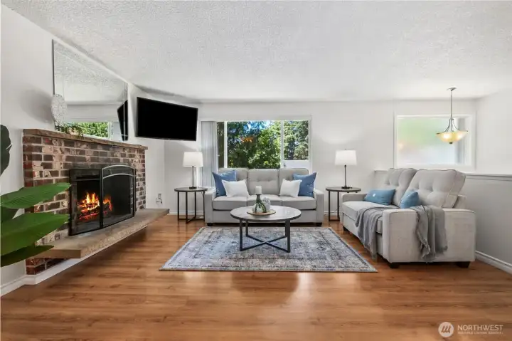 The wood fireplace will be appreciated in the cooler months, creating a bright & cozy atmosphere throughout the winter.  BONUS: The installed flat screen TV stays!