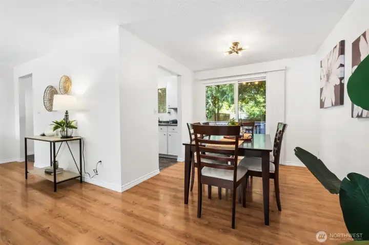 The generous dining area easily accommodates gatherings, and the adjacent kitchen is conveniently tucked away so the cooking mess is hidden, while remaining connected to the main living spaces.