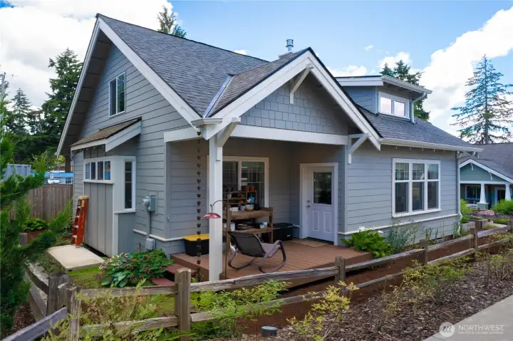 Covered back porch with planting bench (how would you use this space?) The concrete platform is perfect for a small shed or greenhouse.
