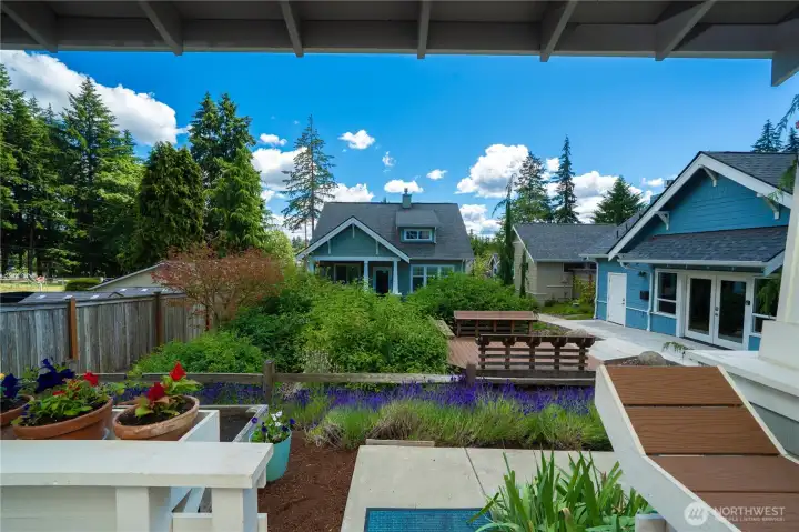 Your front deck view across the rain garden, outdoor seating area and community center
