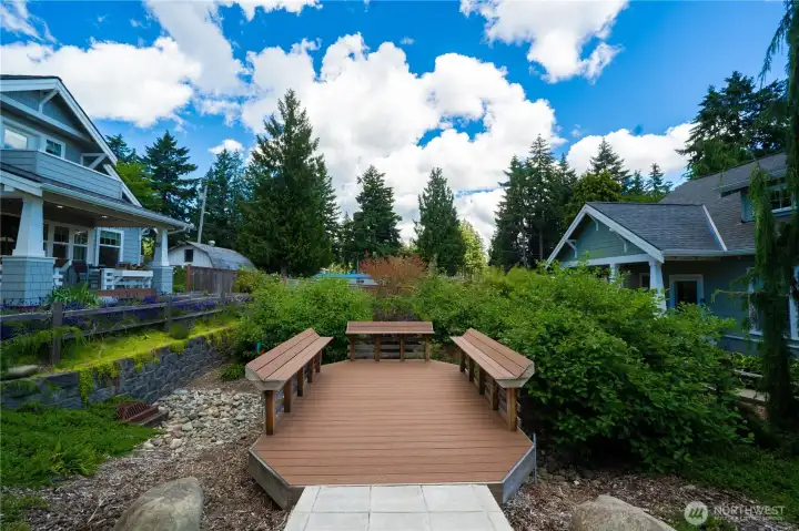 The outdoor gathering space just outside your door looks out to the rain garden