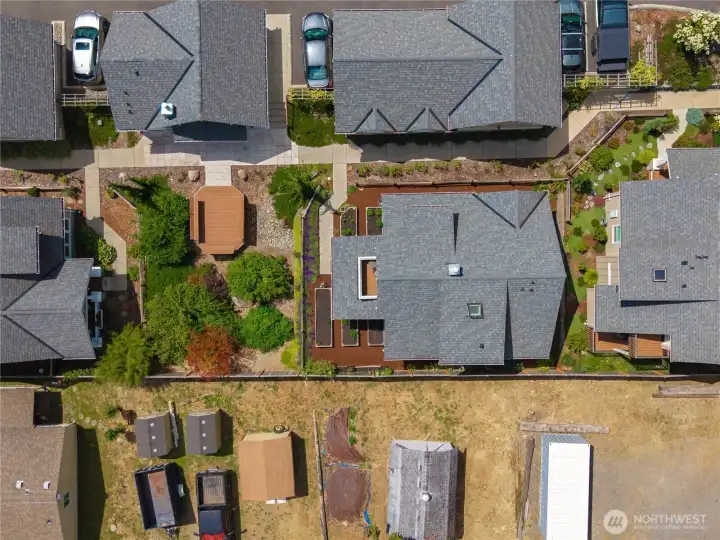 A birds eye view of this beautiful cottage with compact raised bed gardening.