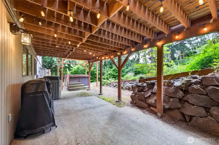 Patio on bottom floor leads to hot tub and lower garden access Patio on bottom floor leads to hot tub and lower garden access