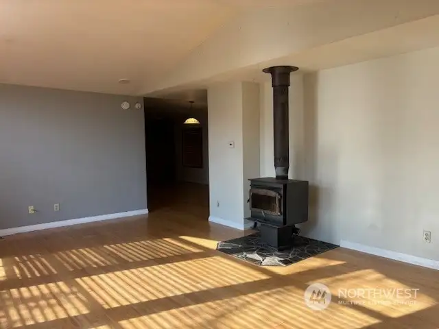 The living room features a wood-burning stove for warmth and wintertime ambiance.