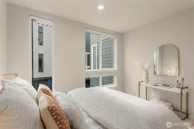An alternative view of the bedroom showcasing the bright and airy feel of the room. The minimalist decor and soft lighting create an inviting space to relax and recharge.