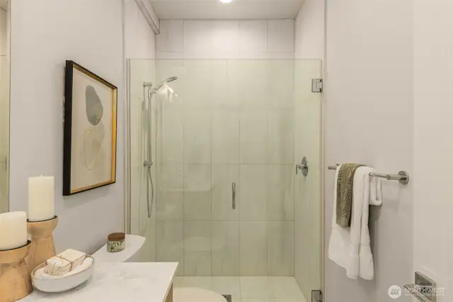 Step into luxury with this pristine glass-enclosed shower. Designed for relaxation, this spa-like space invites you to unwind and refresh in style.