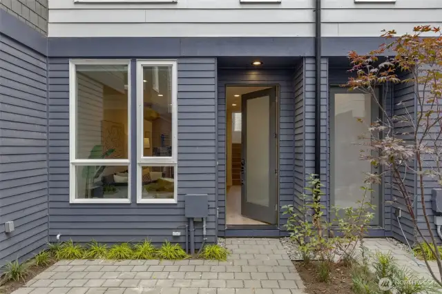 Step through the front entry and into the bright and open main level. Large windows and a welcoming door design bring plenty of natural light into the space, creating an airy ambiance.
