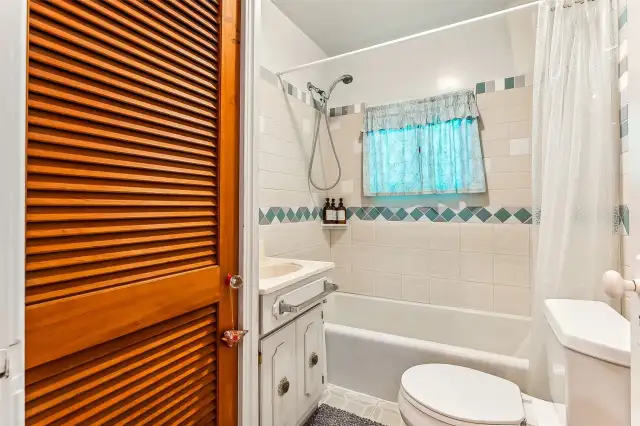 Full bath with tile enclosure.