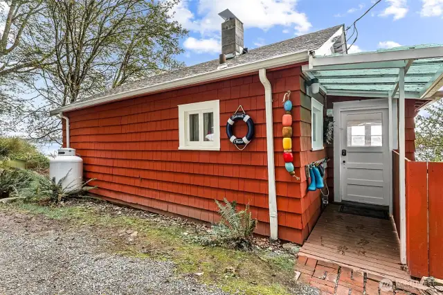 NO STAIRS to enter the main level on the driveway side of the home!! Propane tank runs the kitchen stove and free-standing fireplace.