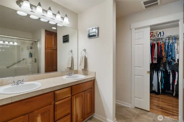 En-suite bath has a walk-in closet, double sinks in the oversized vanity, and a walk-in shower. Custom linen closet, too!